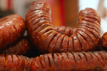 Grilled meat and sausages being served at a lively street festival during the Santos Populares celebration in Lisbon, Portugal. The traditional Portuguese food. Close up, soft focus. Part of a series