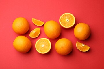 Fresh ripe oranges on red background, flat lay