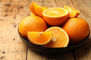 Fresh ripe oranges on wooden table, closeup