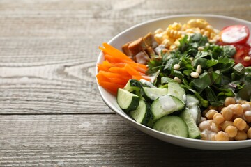 Different healthy vegetarian food on wooden table, closeup. Space for text
