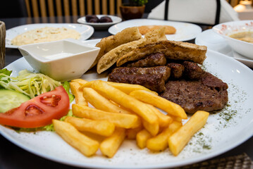 A Balkan Feast: Ćevapi, Pljeskavica, Fries, Salad & Fresh Bread