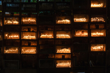 Multiple, burning Hanukkah Chanukah menorahs with candles made from cups of oil stacked on a...