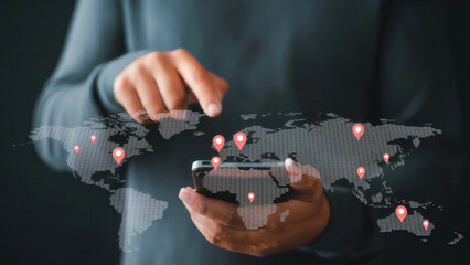 Person using smartphone interacting with digital world map with location pins