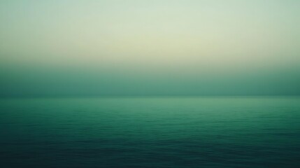 Obraz premium Serene ocean horizon view in teal and green tones, calm water and misty sky background