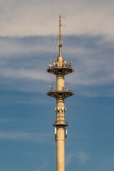 Fototapeta premium Telecommunication tower reaching for the sky on a cloudy day