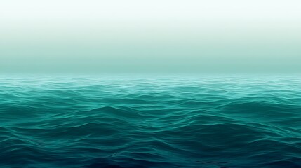 Obraz premium Ocean surface with gentle waves and misty horizon creating a serene seascape ambiance