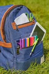 a school backpack ready for school, a blue glass backpack filled with school supplies for school on...