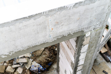 Closeup view of concrete beam on wall during house renovation. messy demolition phase of...