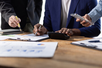 Business people working together, analyzing financial documents. Financial advisor and auditor are...