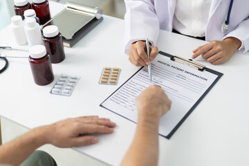 Friendly female doctor discussing diagnosis with patient during medical consultation in clinic...