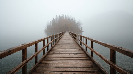Fototapeta premium A wooden bridge leads to a foggy island blending nature and infrastructure