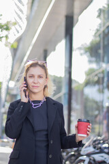 Fototapeta premium Two businesswomen in diverse suits bond during a relaxed meeting, sharing happiness, inspiration, confidence, teamwork and professional connections.