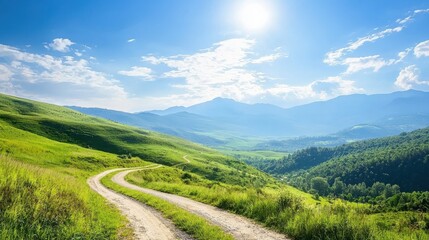 A winding dirt path cuts through vibrant green hills under a bright blue sky with scattered clouds and distant mountains.