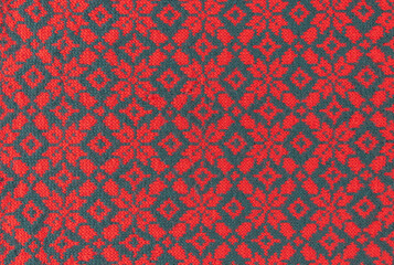 knitted christmas pattern with leaves and stars in red and green