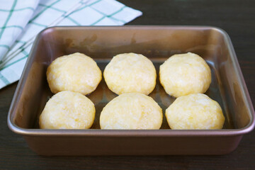 Ball shaped dough in the baking tray for baking Brazilian cheese bread or Pao de Queijo