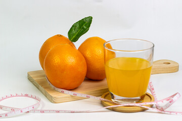 Fresh Orange Juice and Oranges with Measuring Tape for Healthy Lifestyle