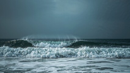 Fototapeta premium Raging sea with towering waves smashing against the beach