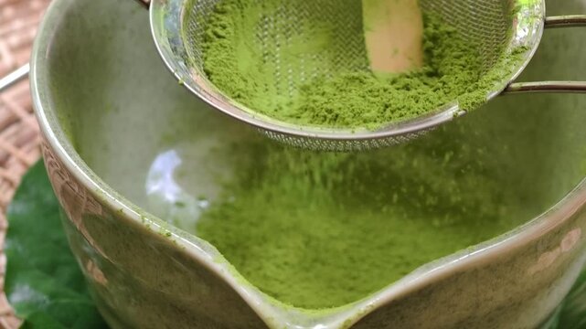 Matcha green tea powder on a net strainer