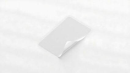 Isolated white card with curled corner on a white surface creating a minimalist and clean presentation