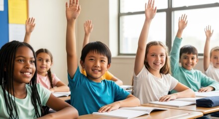 Diverse group of happy elementary school students raising hands in a classroom setting