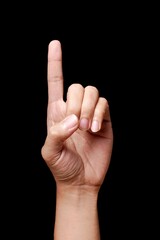 Raised index finger gesture on black background.