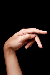 Graceful hand pose on black background.