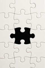 Obraz premium Empty puzzle piece in a nearly completed jigsaw puzzle