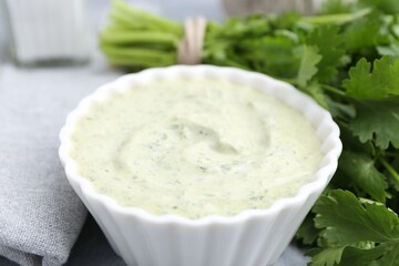 Tasty cilantro sauce in bowl on grey table, closeup
