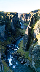 Majestic cliffs and verdant moss blanket the canyon as a crystal-clear river flows through the heart of Icelands dramatic landscape. Explore natures artistry at this serene location.