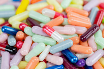 Top view flat lay of colorful medicine capsules. A background texture of various pharmaceutical...