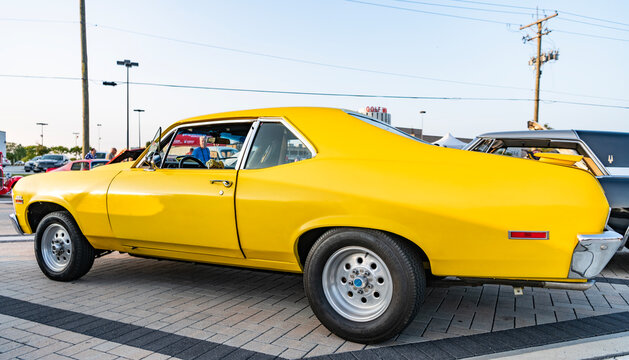 Park Ridge, Illinois, USA - August 21, 2024: yellow car of Chevrolet Nova SS. Chevy Camaro outside. yellow car parked at auto show, side view. 1972 Chevrolet nova SS retro car.