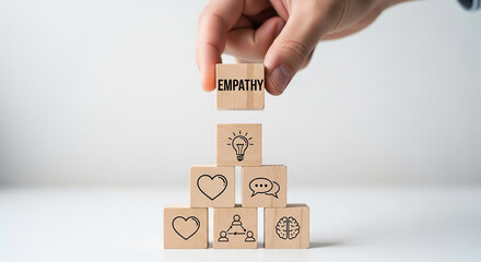 Hand stacking empathy block on others with symbols of care love and support representing emotional intelligence human connection and compassionate leadership

