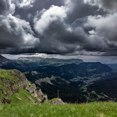 Fototapeta premium dark storm clouds rolling over alpine valley near Seceda, Dolomites, Italy