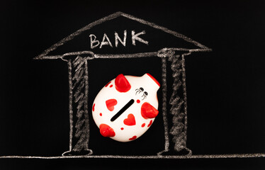 Funny piggy bank with a human heart symbol against the background of a drawn bank building