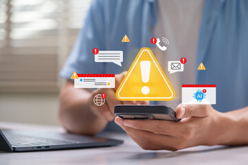 Scam alerts and cybersecurity warnings shown on a smartphone while man checks messages at home. digital fraud, phishing attacks, data breaches, cyber attack, AI threat and mobile malware threats