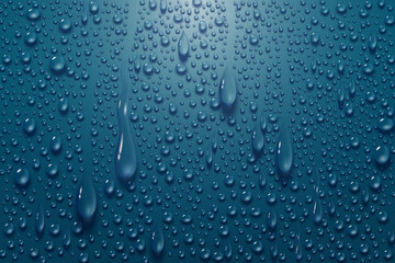 Realistic water drops background on blue glass surface.
