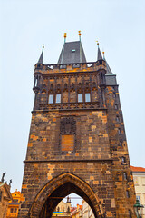 Tower of Charles Bridge from old town of Prague. Historic stone tower in Prague, featuring...