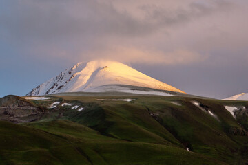 Palandoken mountain covered with snow in fall with green lands