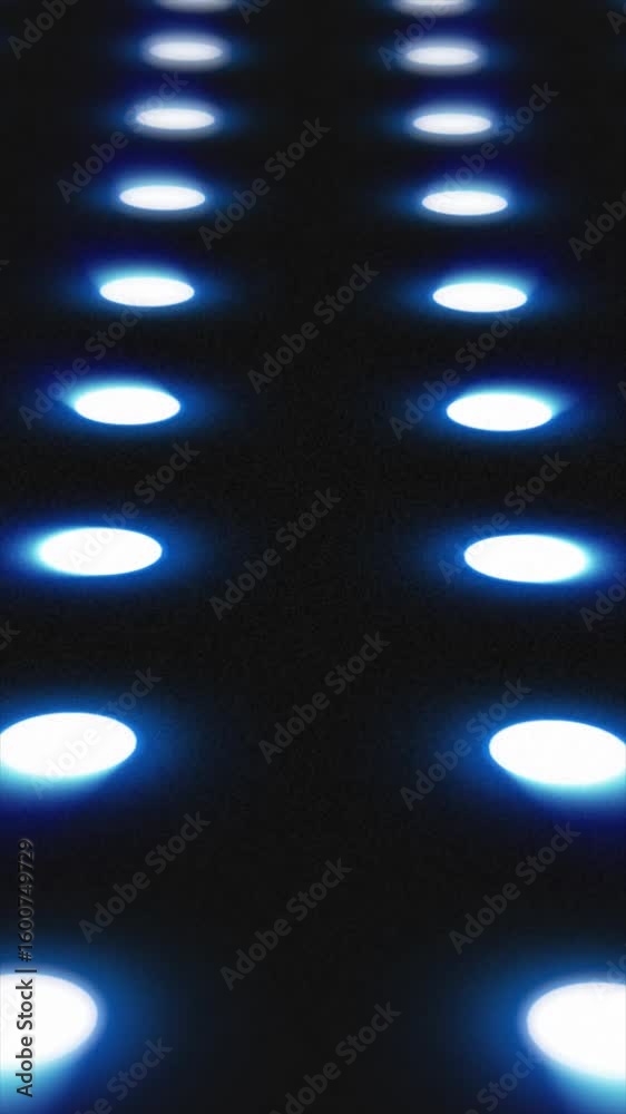 Poster blue illuminated circles in a grid pattern glowing over a dark surface, creating a futuristic led lo
