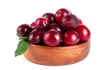 Fresh raw ripe cherry plum with leaves. Bowl of tasty farm bright red cherry plum fruits, in wooden craft bowl on white wooden background copy space