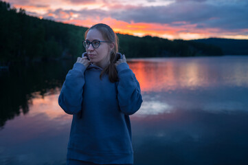 Woman sitting on the pier, closeup portrait, beauty summer sunset