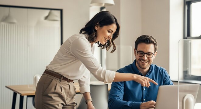 Smiling Business Colleagues Collaborating on Laptop Woman Pointing in Bright Modern Office Environment.