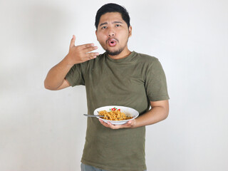 Handsome Asian man enjoying noodles and feeling spicy. eating lunch concept. isolated white background