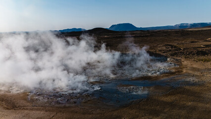 Steam billows from a Hverir geothermal site in Iceland, showcasing the raw power of nature.