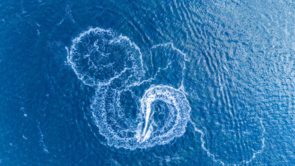 Aerial View of Jet Ski Making Circles on Blue Tropical Ocean