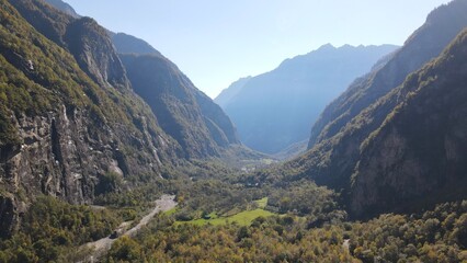 Aerial view of Val Bavona showing steep cliffs, dense forests, and alpine meadows in southern...