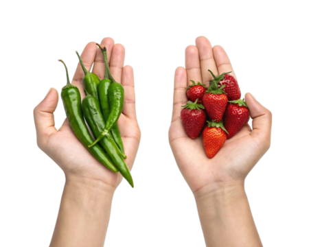 Two hands holding green chili peppers and red strawberries isolated on transparent background, symbolizing contrast, choice, health, or food diversity concepts