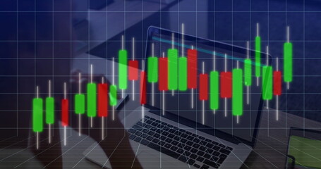 Displaying candlestick chart overlay on office wood desk, with laptop, smartphone and coffee mug