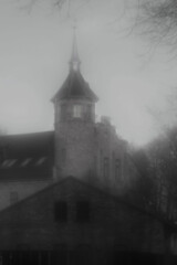  Hazy Liepāja castle: turreted architecture emerges from the fog, evoking mystery and gothic charm. Atmospheric, historic, and eerie. © Martins