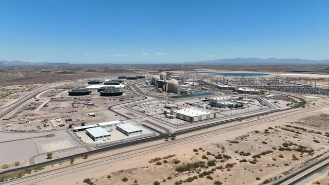 Aerial view of the Palo Verde Nuclear Power Plant, a sprawling industrial complex amidst the arid landscape, contrasting with the clear blue sky, Tonopah, Arizona, United States.